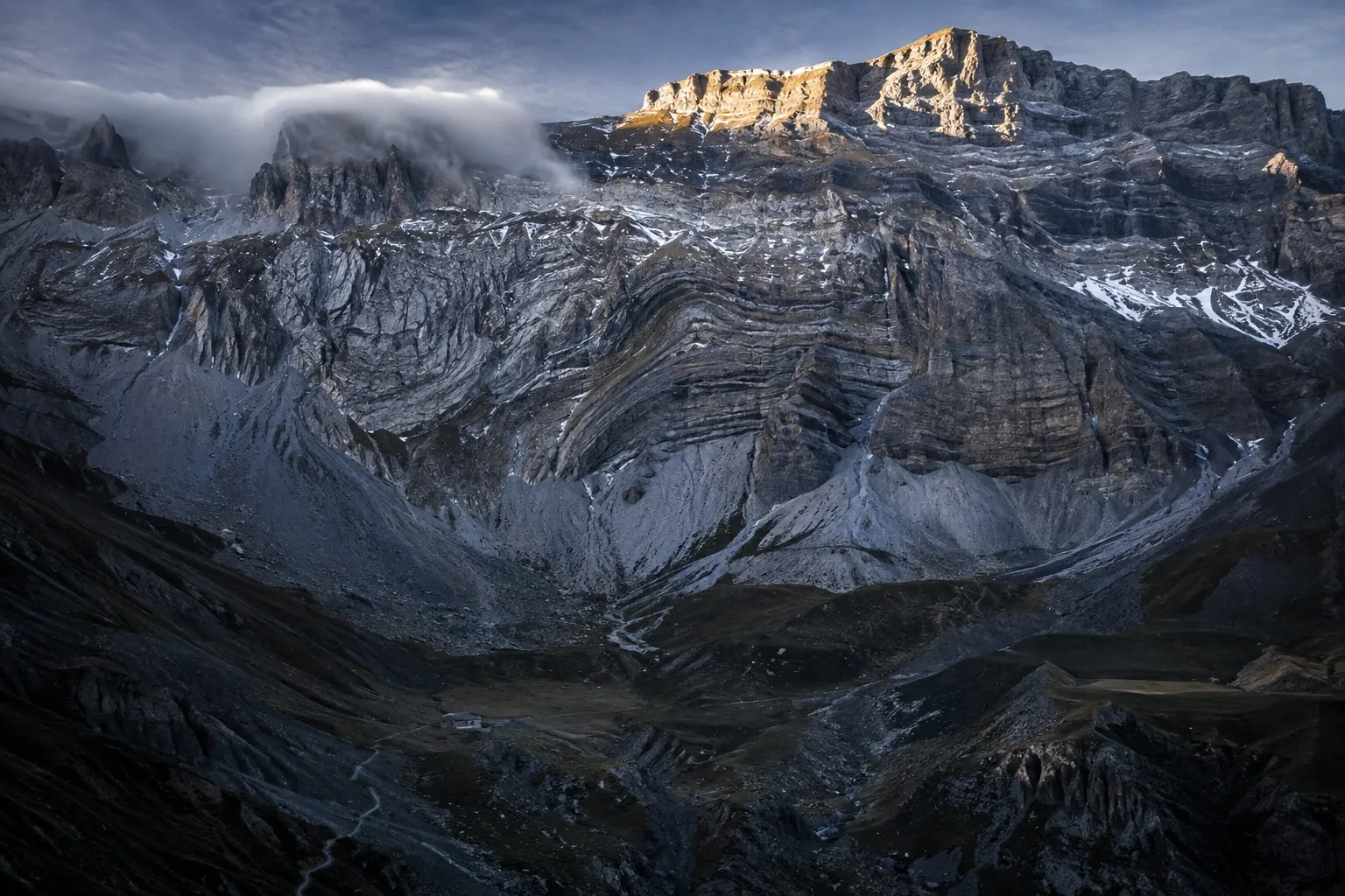 The Alps. The sky darker above, and in the rock the layers he counted.