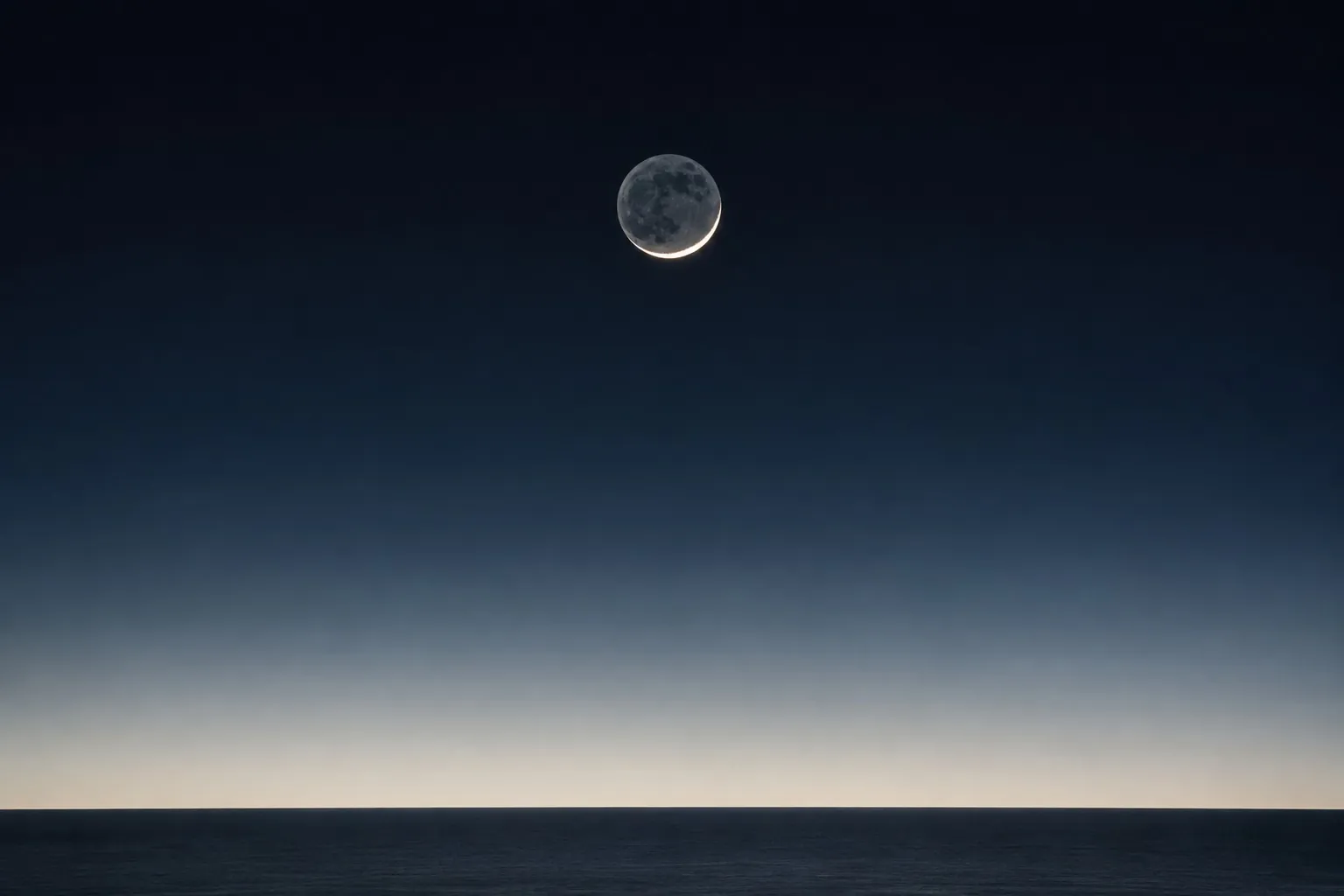 What he was explaining. The old moon in the new moon’s arms.